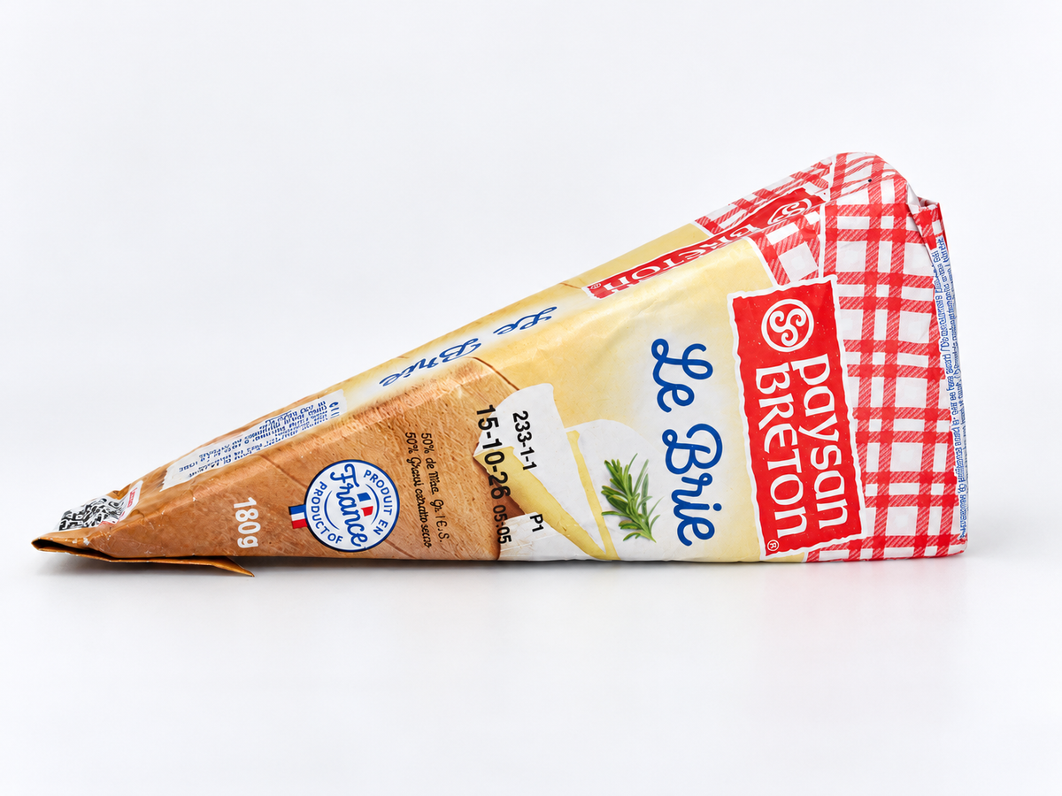 A wedge of Dayson Breton Se Brie cheese in its packaging, featuring a red and white checkered pattern on the top, a light beige center, and a brown rind, photographed on a clean white background.